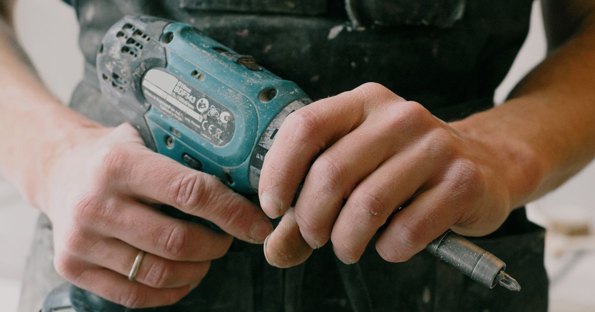 Contractor preparing tools and safety equipment before storm damage repair work
