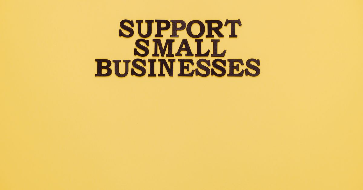Small business owner reviewing an insurance policy document at their desk